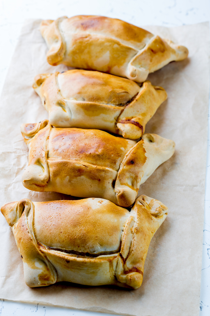 Chilean EMPANADAS DE PINO. Empanadas on white background. Vertical